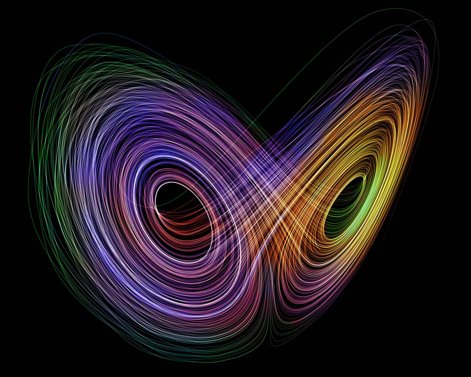 Colorful concentric circles, similar to unspooling threads, create an abstract shape in a field of black.