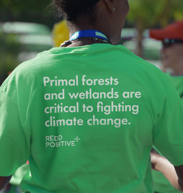 Woman in a green shirt with text on the back